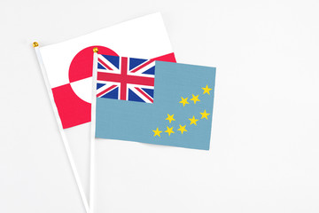 Tuvalu and Greenland stick flags on white background. High quality fabric, miniature national flag. Peaceful global concept.White floor for copy space.