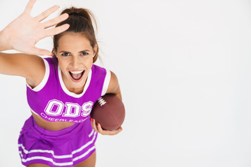 Cheerleader woman holding handball for american football.