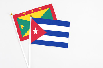 Cuba and Grenada stick flags on white background. High quality fabric, miniature national flag. Peaceful global concept.White floor for copy space.