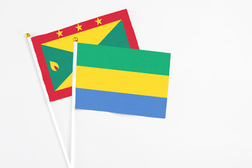 Gabon and Grenada stick flags on white background. High quality fabric, miniature national flag....