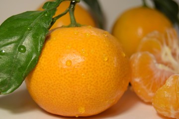 tangerines with leaves on wooden background