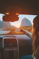 Woman with cup in car on road trip traveling relaxing drinking coffee adventure lifestyle vacations...