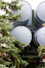 Launcher. The symbol of war. Anti-aircraft missiles on a background of trees. Military missiles.