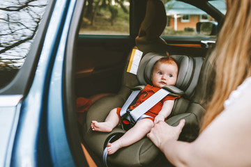 Baby sitting in safety car seat family road trip vacations lifestyle child care transportation...