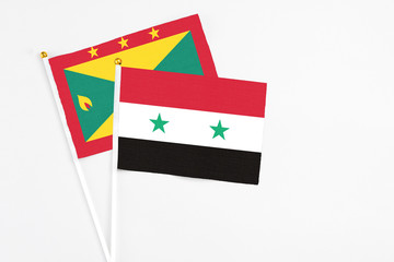 Syria and Grenada stick flags on white background. High quality fabric, miniature national flag. Peaceful global concept.White floor for copy space.