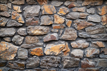 Stone wall. Wall of hewn wild stone. Stone background.