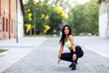 Long dark hair girl exercise on the street after jogging