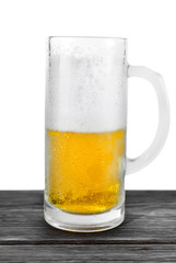 Halved mug of beer isolated on a white background