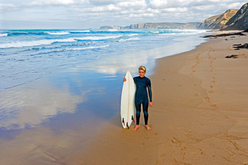 Aerial from a young surfer ready to surf at the atlantic ocean