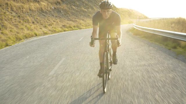 Male cyclist riding downhill Lake Wakatipu New Zealand