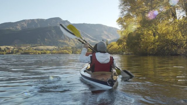 Male and female kayaking outdoor Lake Wakatipu Fjordland