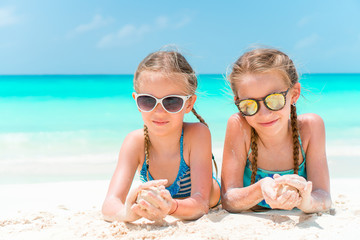 Portrait of two beautiful kids looking at camera background of beautiful nature of blue sky and turquoise sea