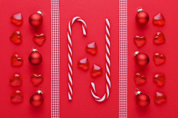 red background with hearts, baubles and christmas candy cane