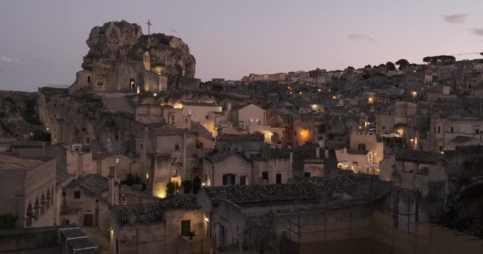 Rock Church of Santa Maria di Idris. View at sunset. Streets and houses made in the famous Sassi carved into the rock.