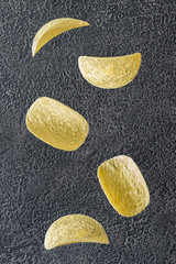 Potato chips on the black background
