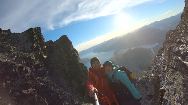Couple trekking taking selfie on smartphone The Remarkables