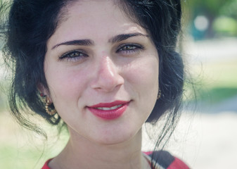 Beautiful girl in the foreground white skin, red lips, green eyes and black hair, look away very concentrated