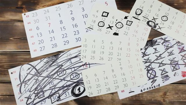 Sheets of a calendar month on a wooden natural background