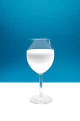 Glass of milk in blue and white background