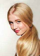Naklejka premium Portrait of beautiful blonde young woman face. Spa model girl with fresh clean skin isolated on a white background