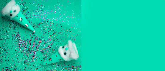 Christmas beautiful homemade snowmans on festive neo mint trendy color background with confetti