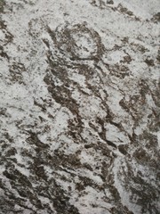 Dark gray and light gray marble pattern with black patches texture background.
