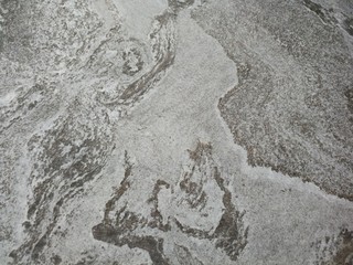 Dark gray and light gray marble pattern with black patches texture background.