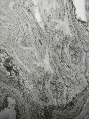 Dark gray and light gray marble pattern with black patches texture background.