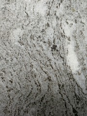 Dark gray and light gray marble pattern with black patches texture background.