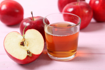 apple juice from red apples on the table.