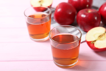 apple juice from red apples on the table.
