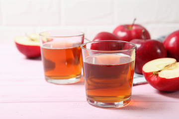 apple juice from red apples on the table.