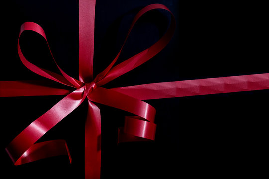 Online shopping singles day sale concept. red ribbon on black background with copy space for text singles day sale.