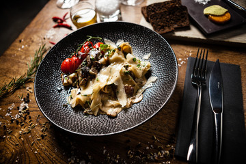 Black Angus Pasta served in a black bowl in restaurant