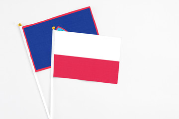 Poland and Guam stick flags on white background. High quality fabric, miniature national flag. Peaceful global concept.White floor for copy space.