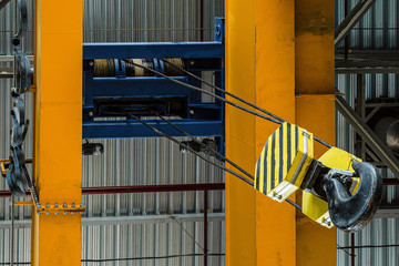 Overhead traveling crane with steel hooks in industrial engeenering plant shop. Steel slings....