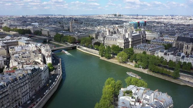  Seine river with boats and skyline of Paris aerial view