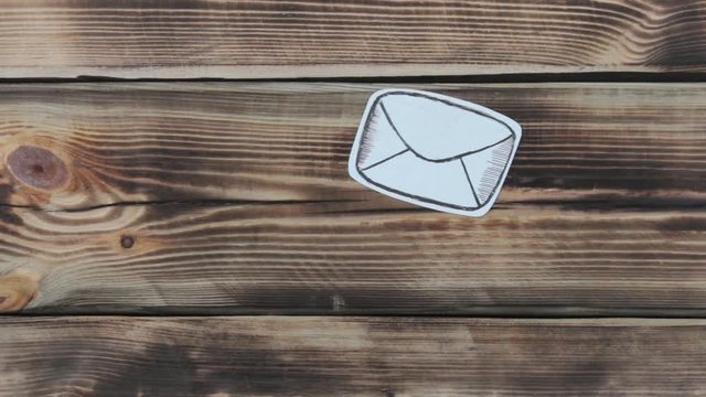 Paper drawing sketches with mail-themed letters on wooden