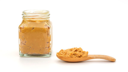 Peanut butter in a spoon and bottle on a white background.