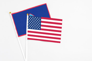 United States and Guam stick flags on white background. High quality fabric, miniature national flag. Peaceful global concept.White floor for copy space.