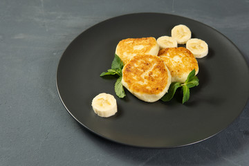 Cottage cheese pancakes on a dark plate