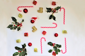 Composition with red berries, holly leafs and berries, balls, pine cones, Christmas decoration on white background.