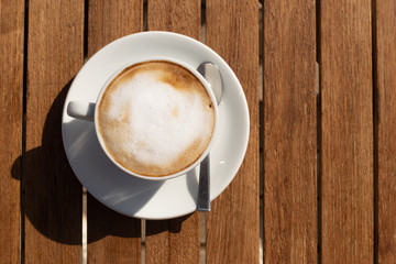 cup of coffee on wooden table