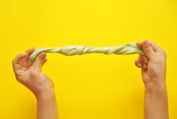 Child hands with slime on background.