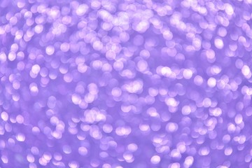 Blurred abstract background with sparkle shiny bokeh. Romantic holiday bokeh background with soft focus and magical shimmering. Christmas and new year card. Purple bokeh backdrop 