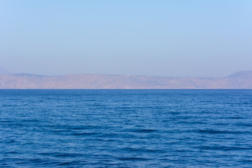 calm Mediterranean sea. mountains on the horizon and blue sky