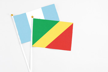 Republic Of The Congo and Guatemala stick flags on white background. High quality fabric, miniature national flag. Peaceful global concept.White floor for copy space.