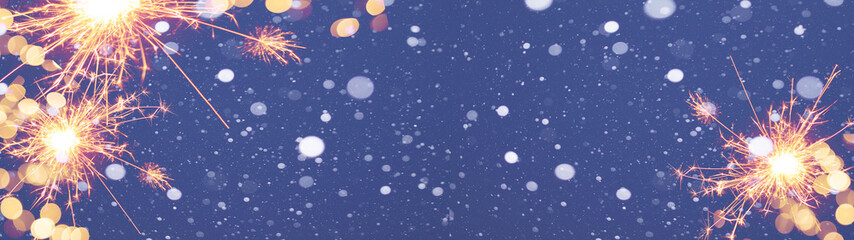 Silvester background panorama banner long - snow with snowflakes, sparklers and lights on blue dark...