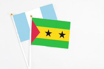 Sao Tome And Principe and Guatemala stick flags on white background. High quality fabric, miniature national flag. Peaceful global concept.White floor for copy space.