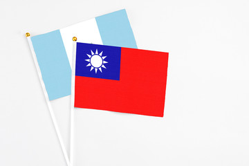 Taiwan and Guatemala stick flags on white background. High quality fabric, miniature national flag. Peaceful global concept.White floor for copy space.